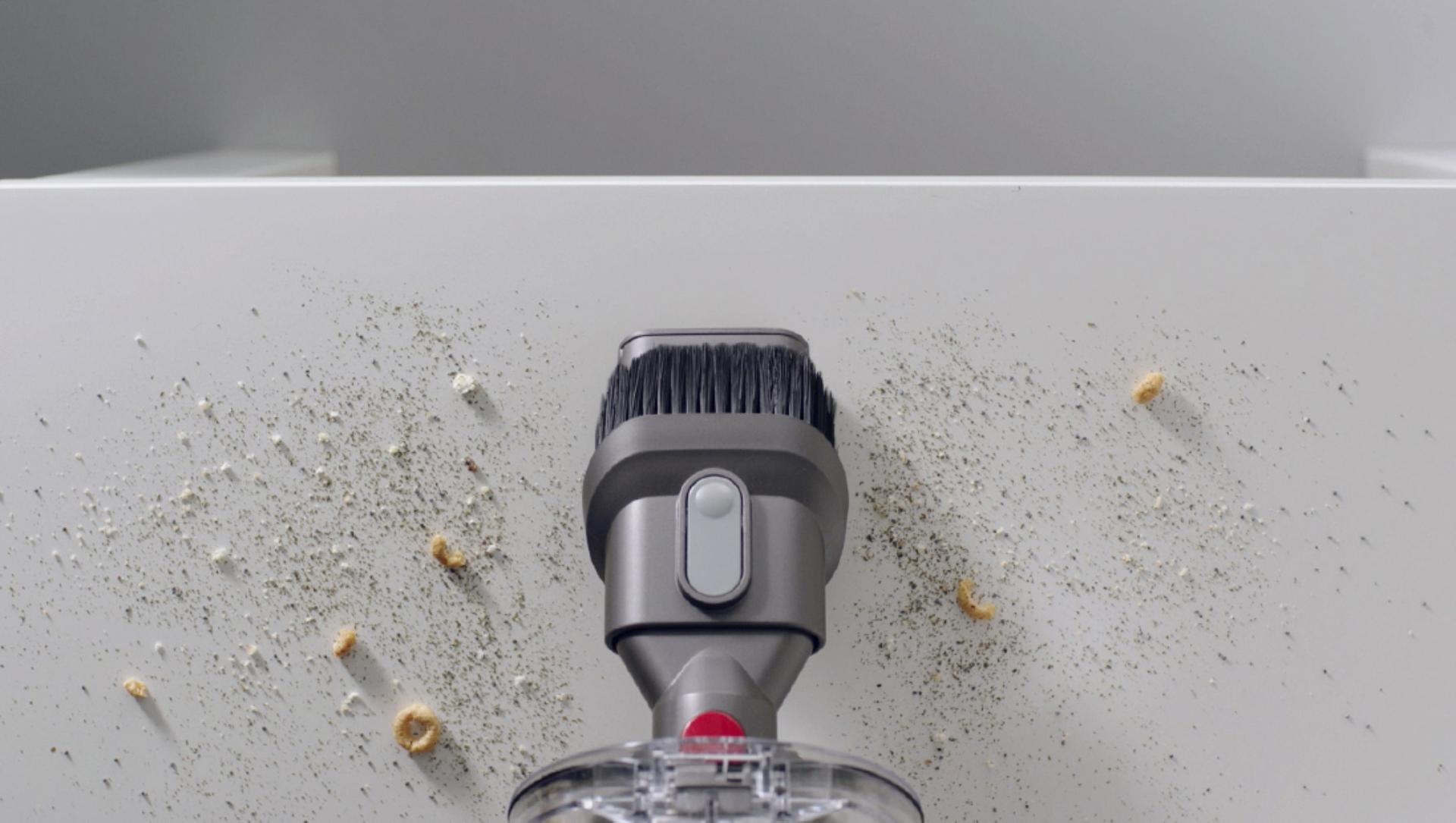 Combination tool cleaning crumbs on a hard surface