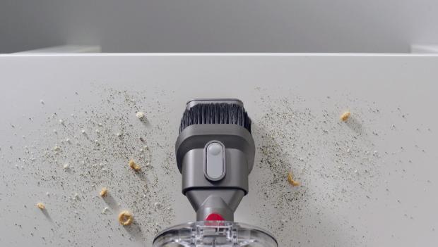 Combination tool cleaning crumbs on a hard surface