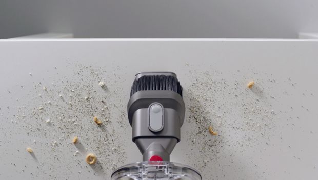 Combination tool cleaning crumbs on a hard surface