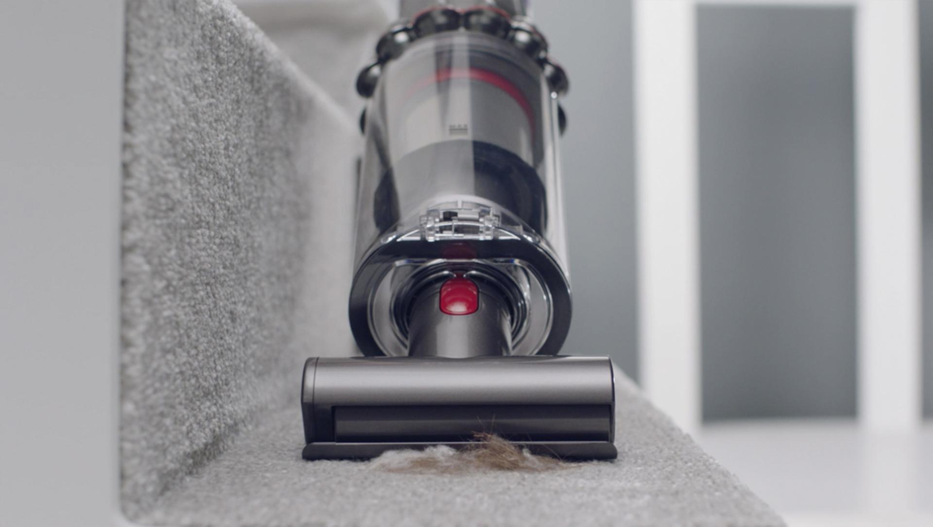 Mini motorised tool cleaning carpet on stairs