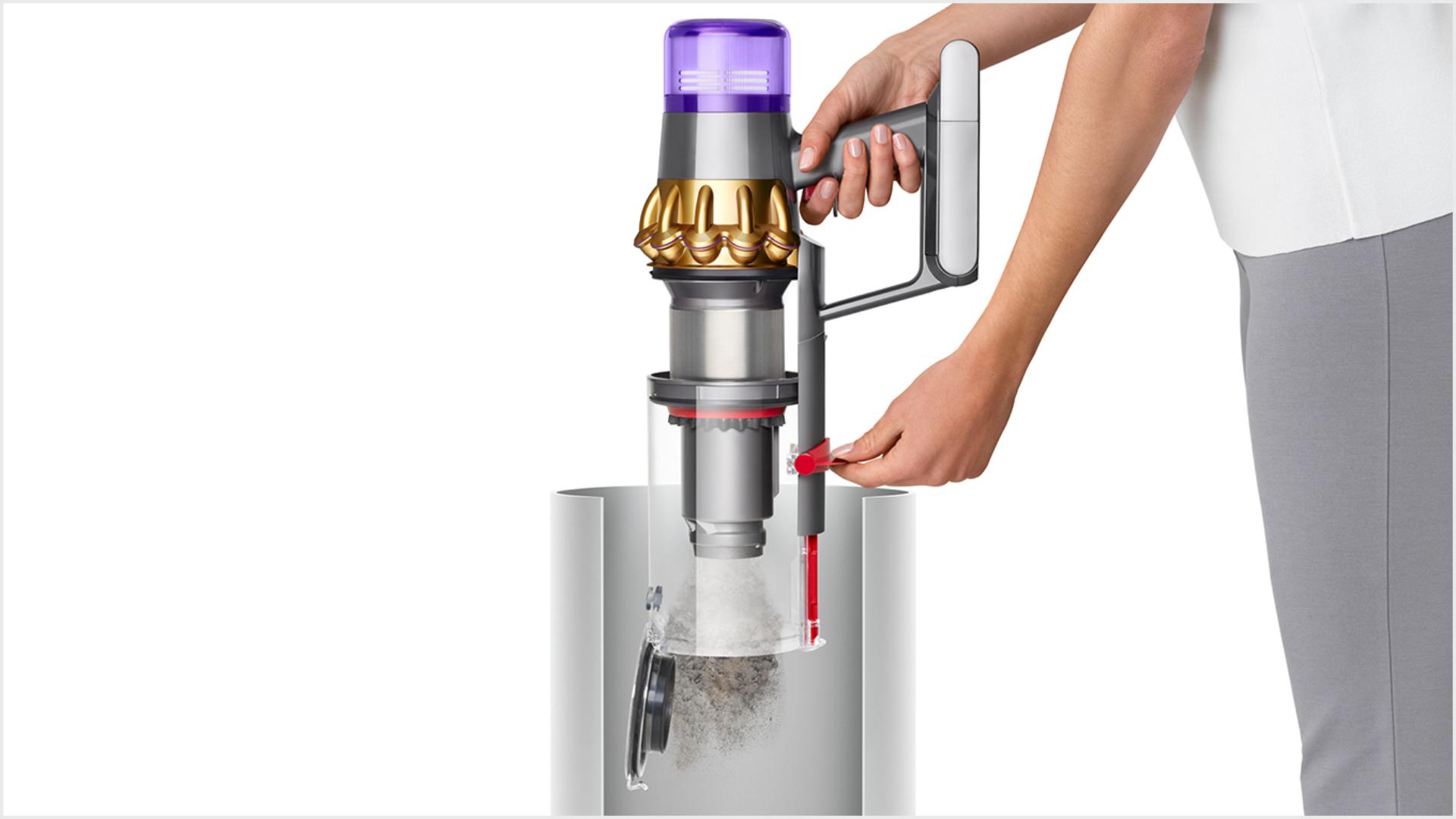Woman emptying Dyson V11 Outsize vacuum into bin