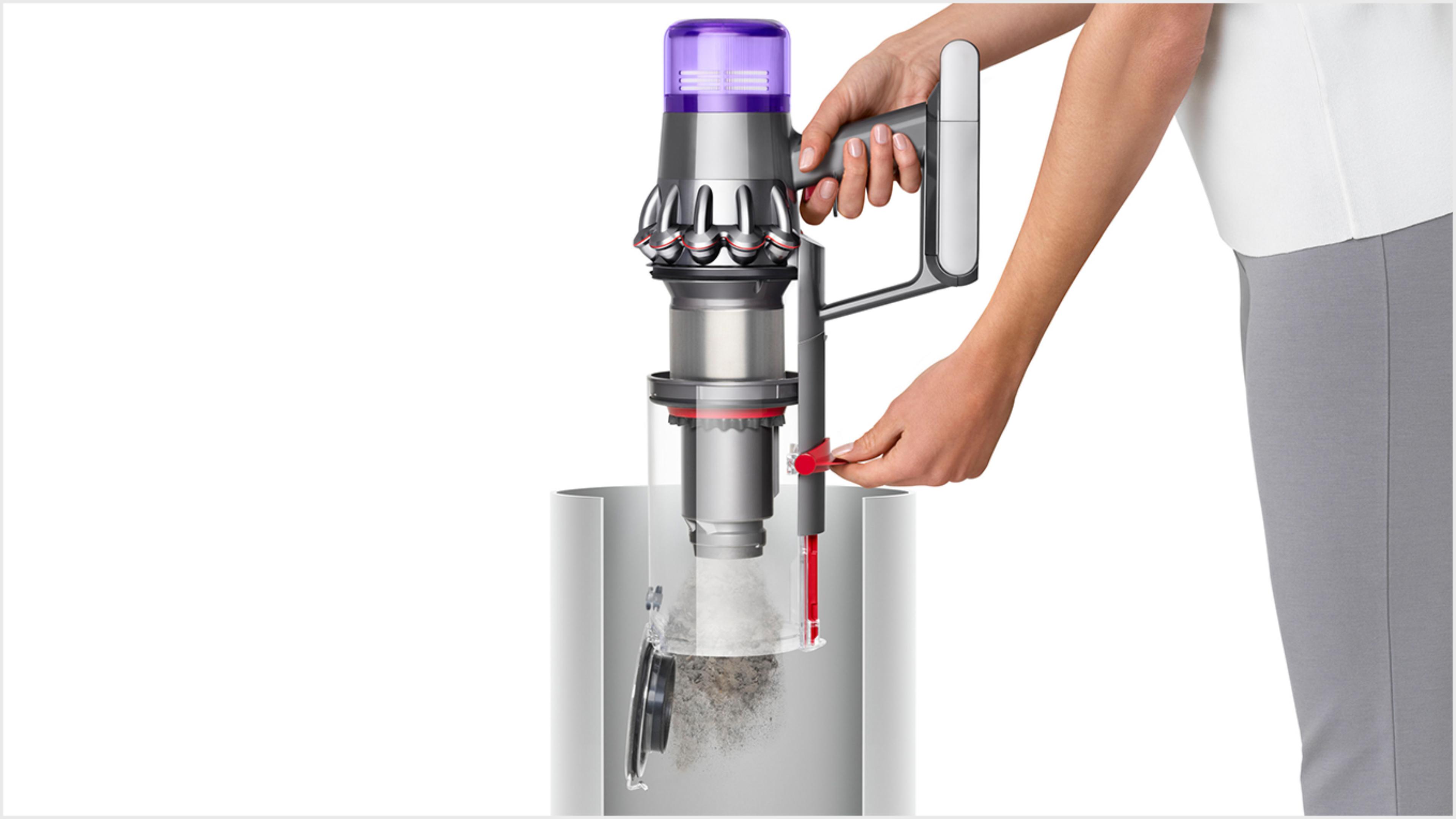 Woman emptying Dyson V11™ vacuum into bin