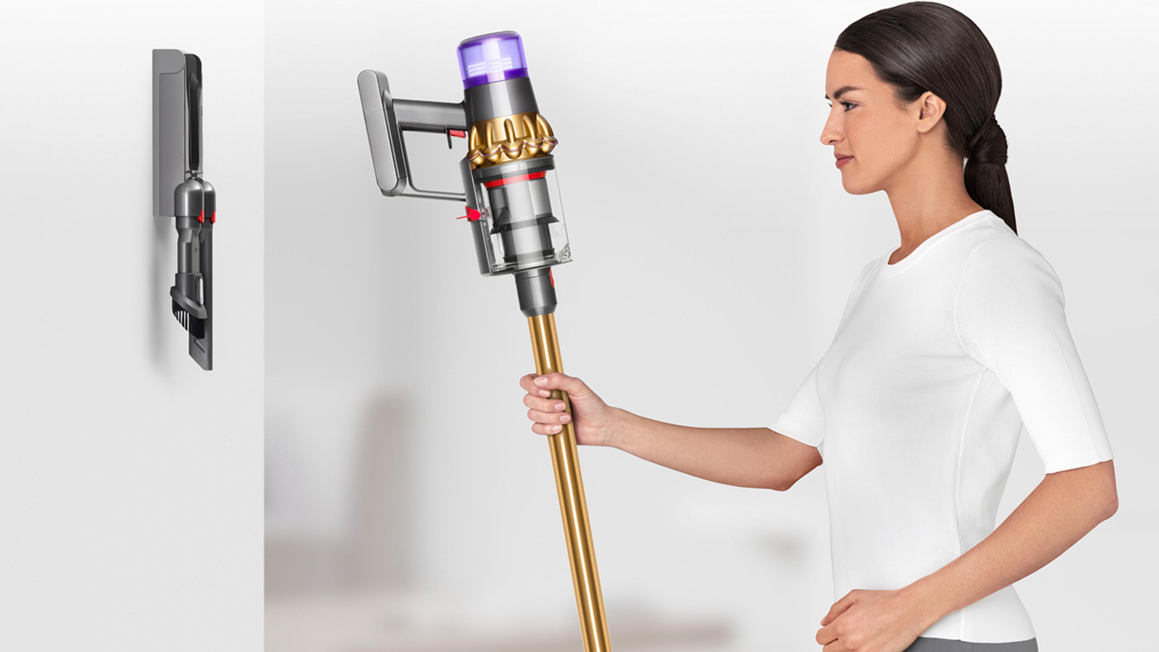 Woman placing Dyson V11™ vacuum into wall charging dock