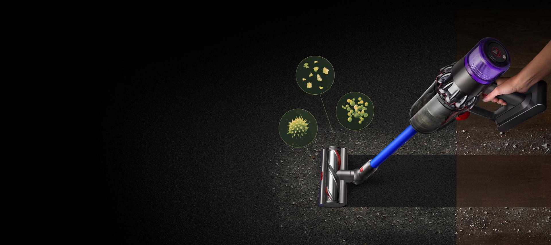 A Dyson V11™ vacuum picking up fine dust, allergens and pollen from the floor.