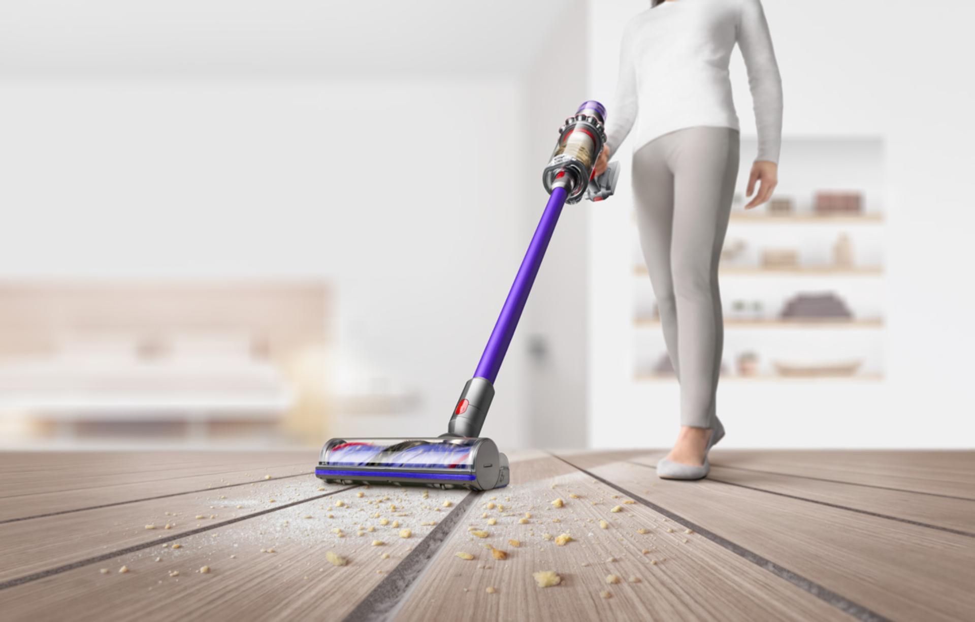 Woman with Dyson V11™ vacuum cleaning floor and ceiling