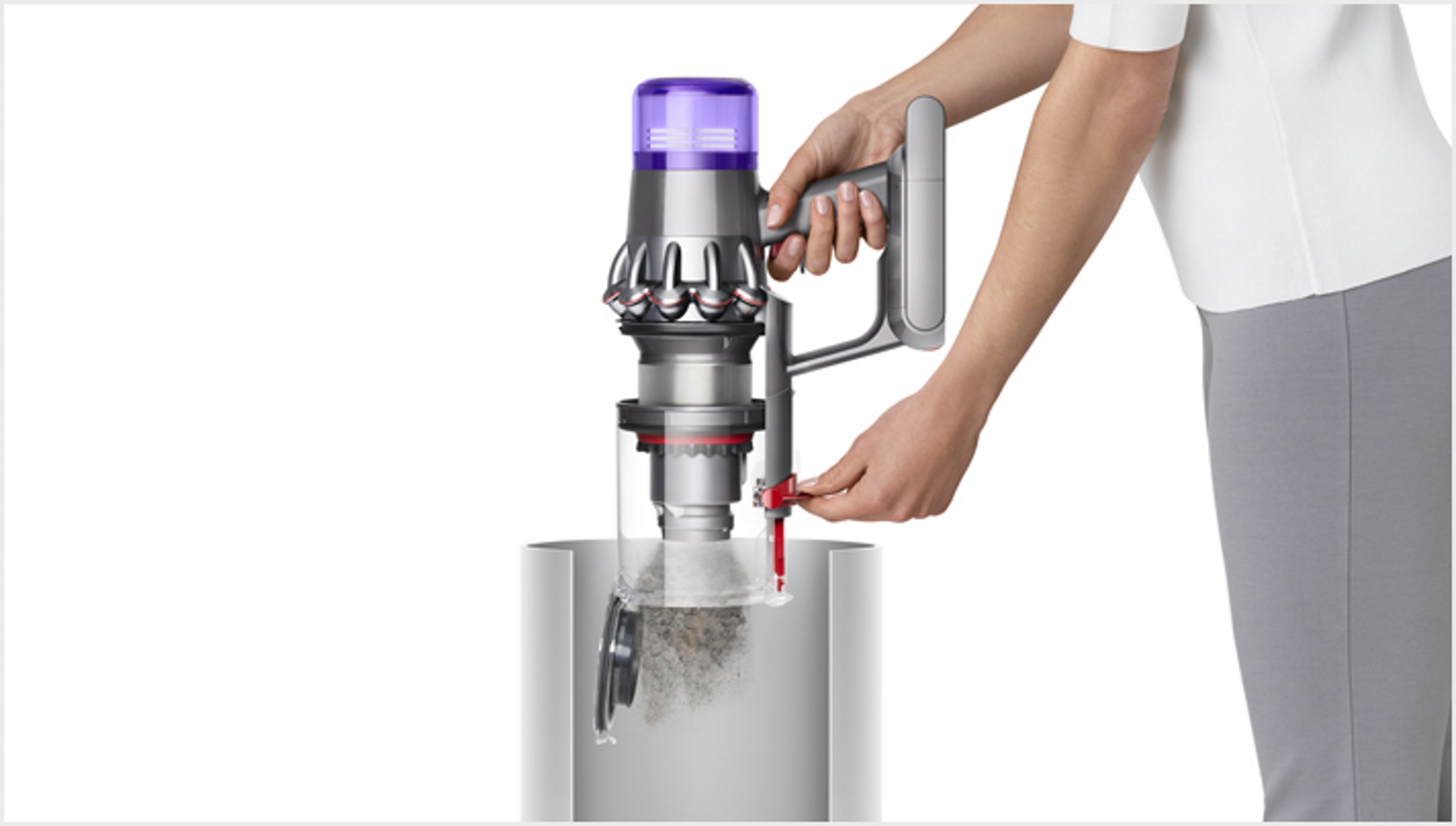 Woman emptying Dyson V11™ vacuum into bin