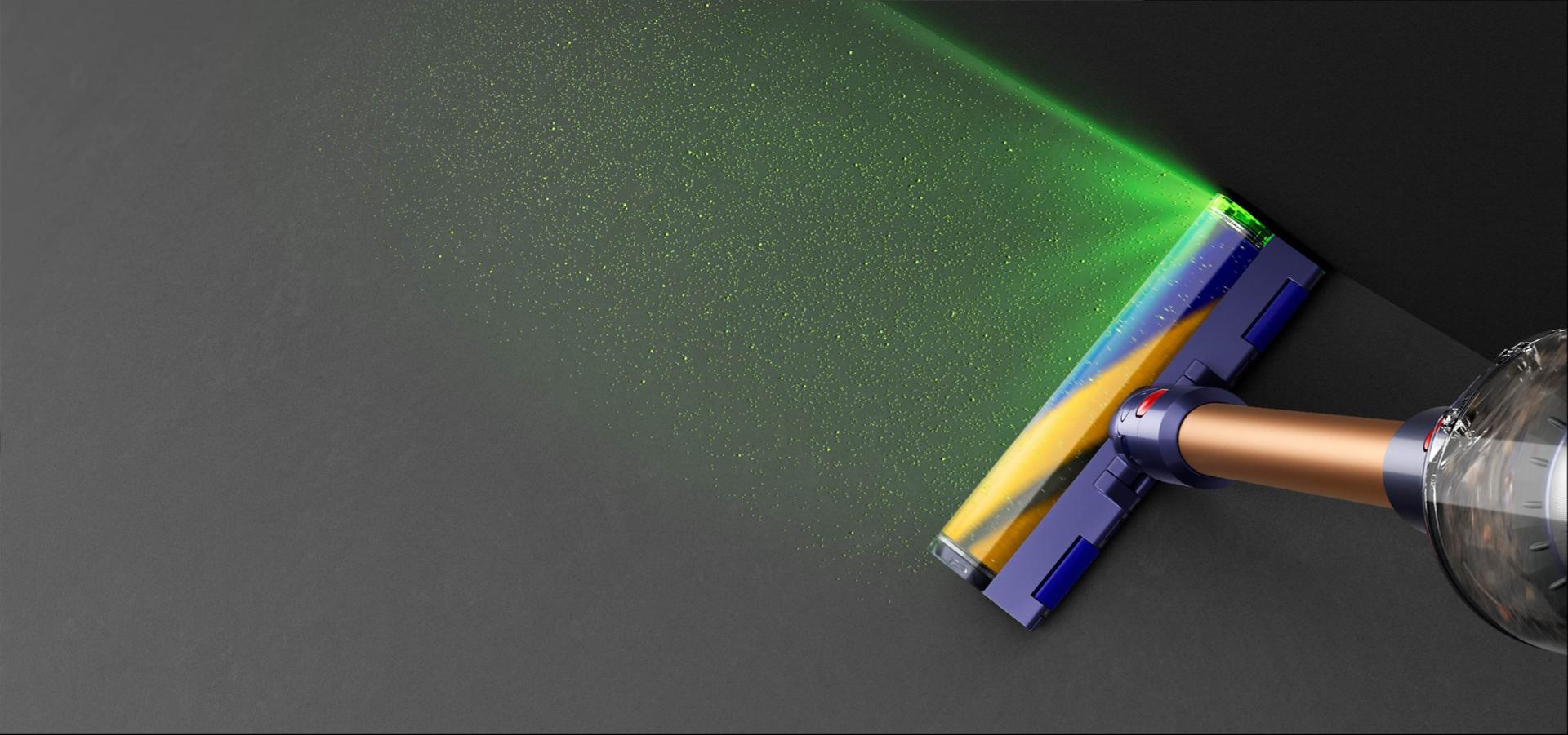 Aerial view of vacuum on hard floor with blade of light revealing hidden dust.