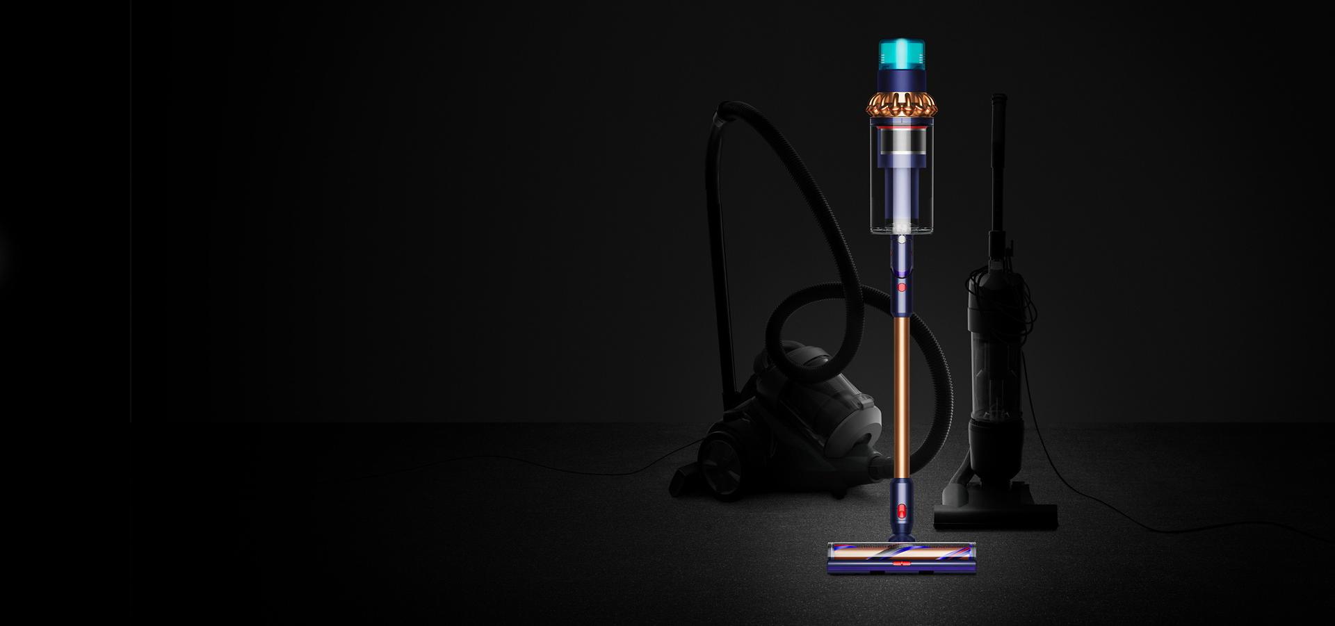 Straight on view of Dyson Gen5outsize in front of two corded vacuums.