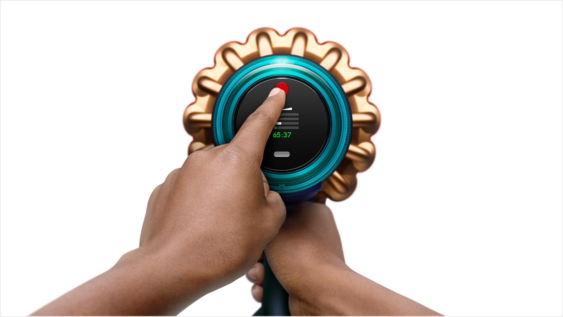 Finger touching the Dyson power button.