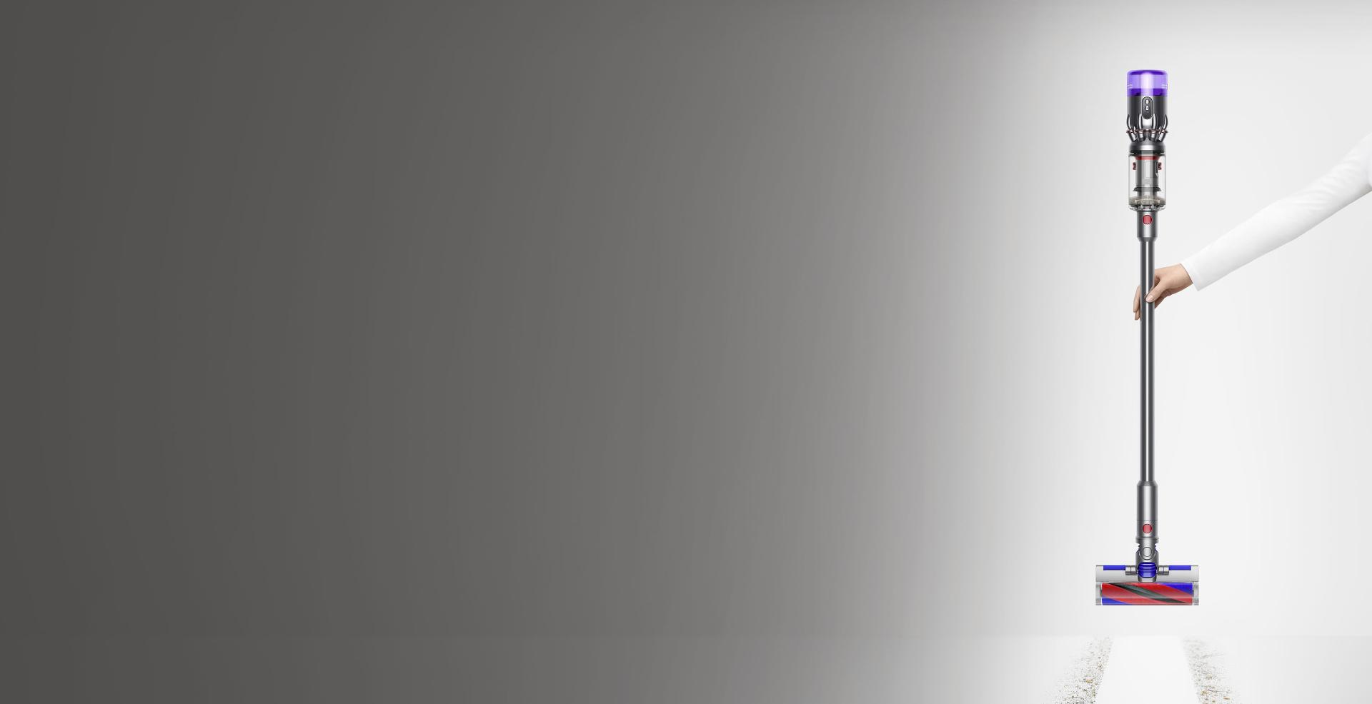 Woman holding Dyson Micro 1.5kg vacuum