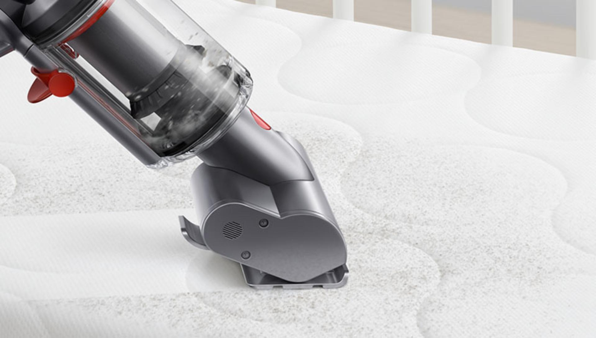 Dyson Micro 1.5kg vacuum cleaning a mattress.