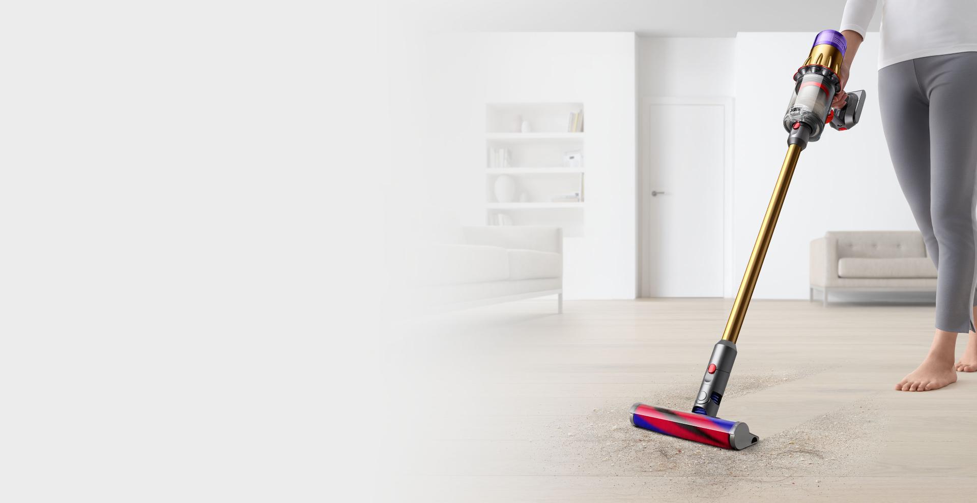 Image of a woman holding a Dyson Digital Slim™ vacuum.