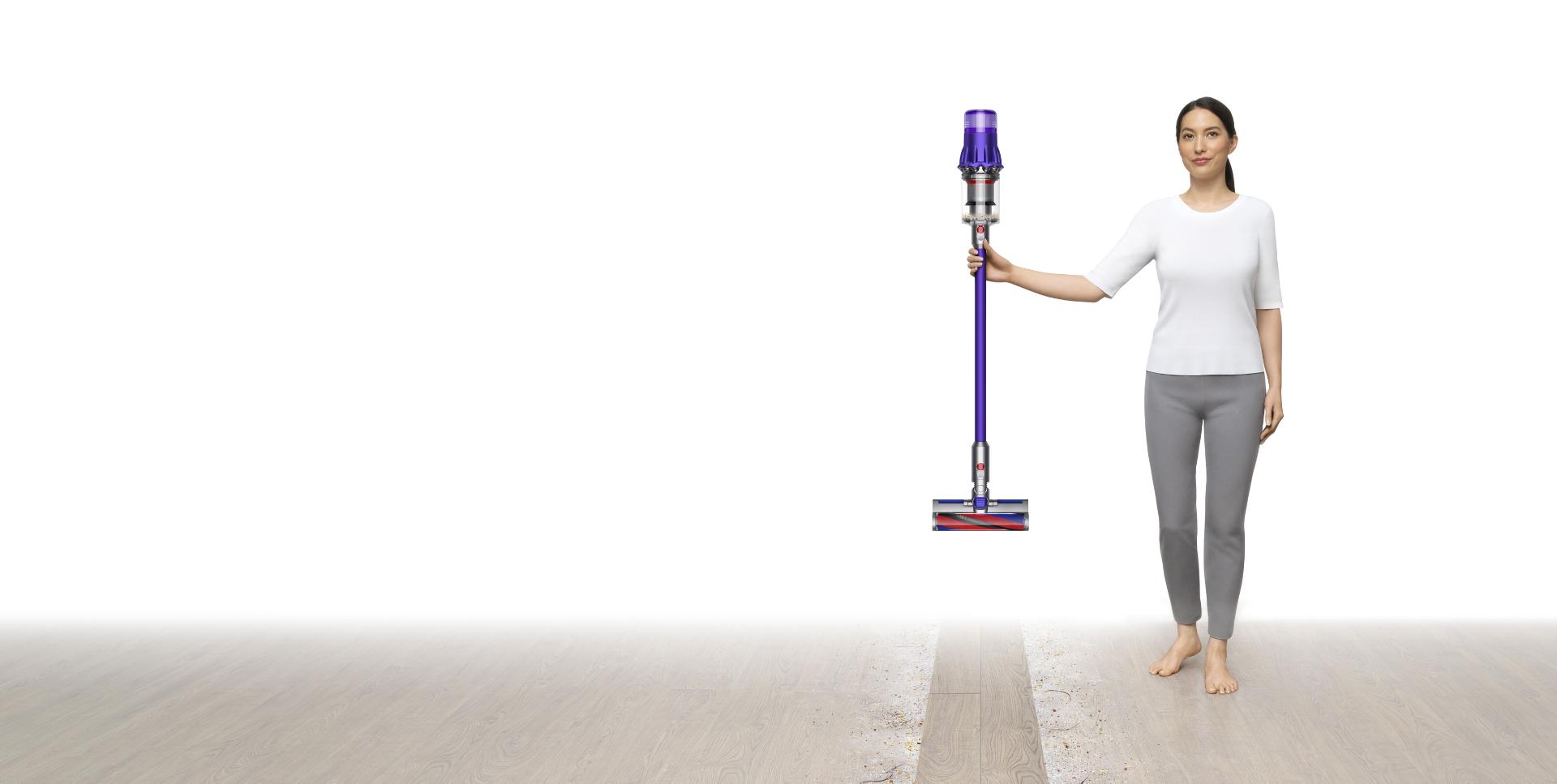 Image of a woman holding a Dyson Digital Slim™ vacuum.