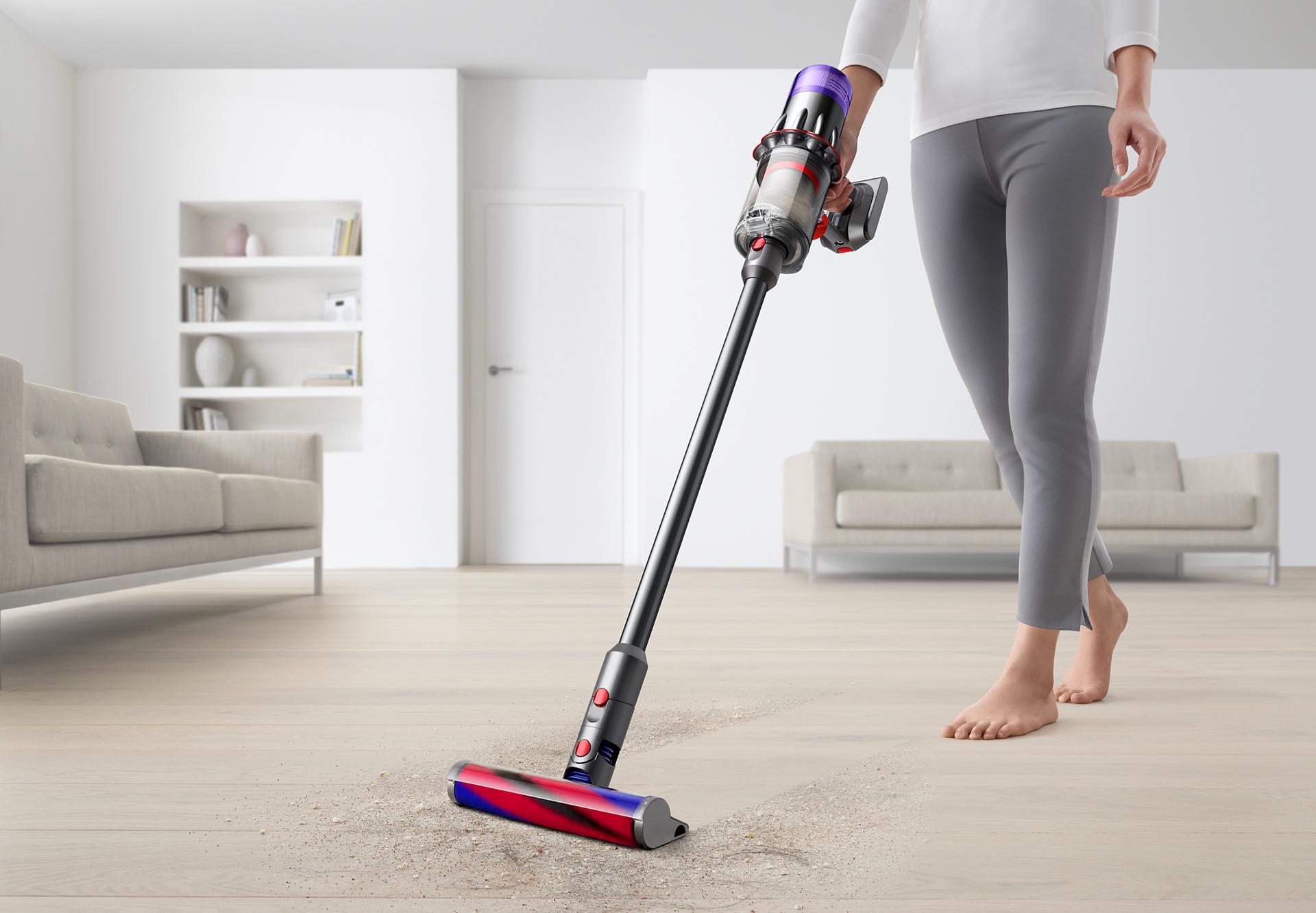 Dyson Digital Slim™ vacuum cleaning a hard floor by a bedroom door.