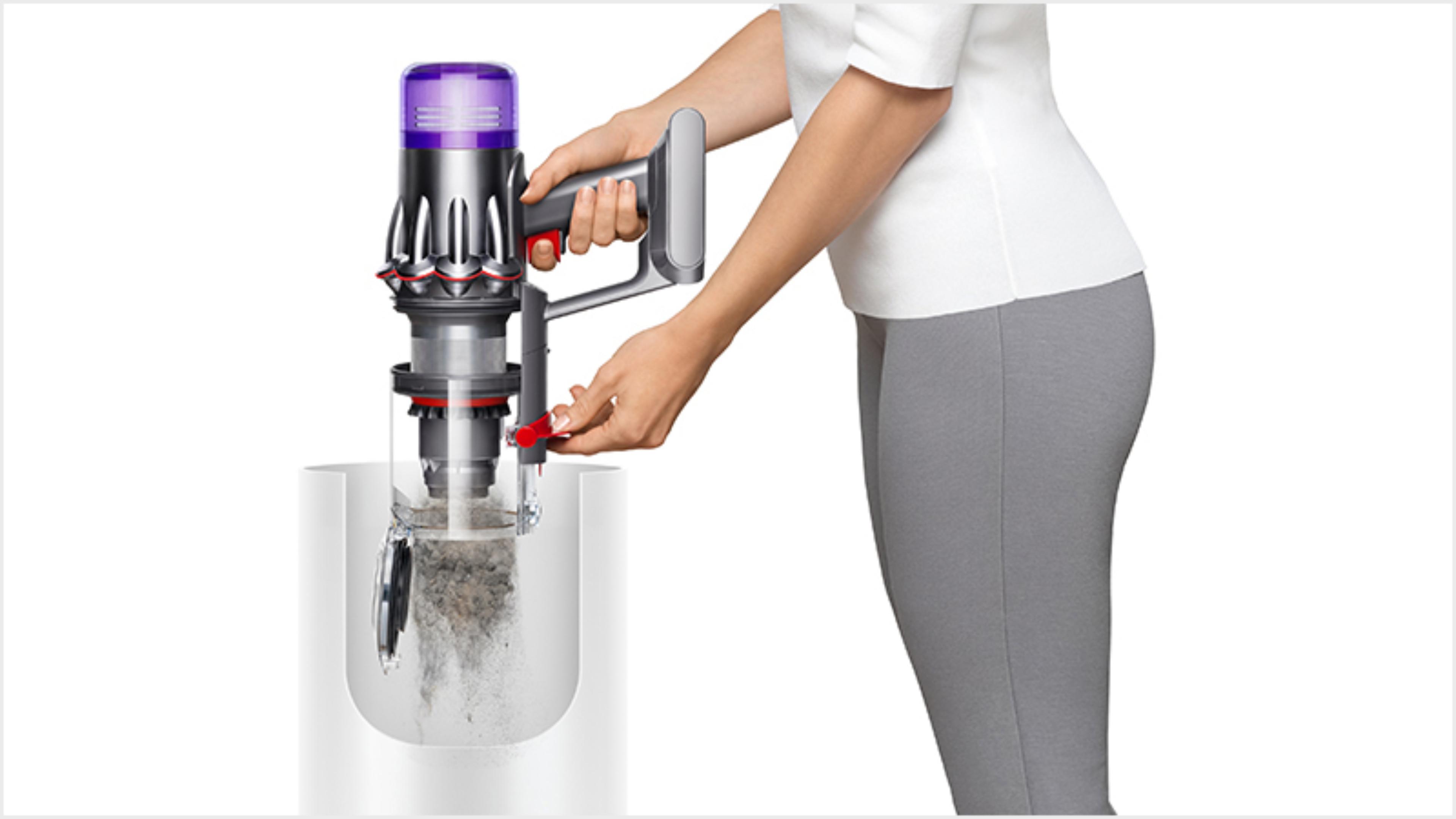 Woman emptying the Dyson Digital Slim vacuum into the bin
