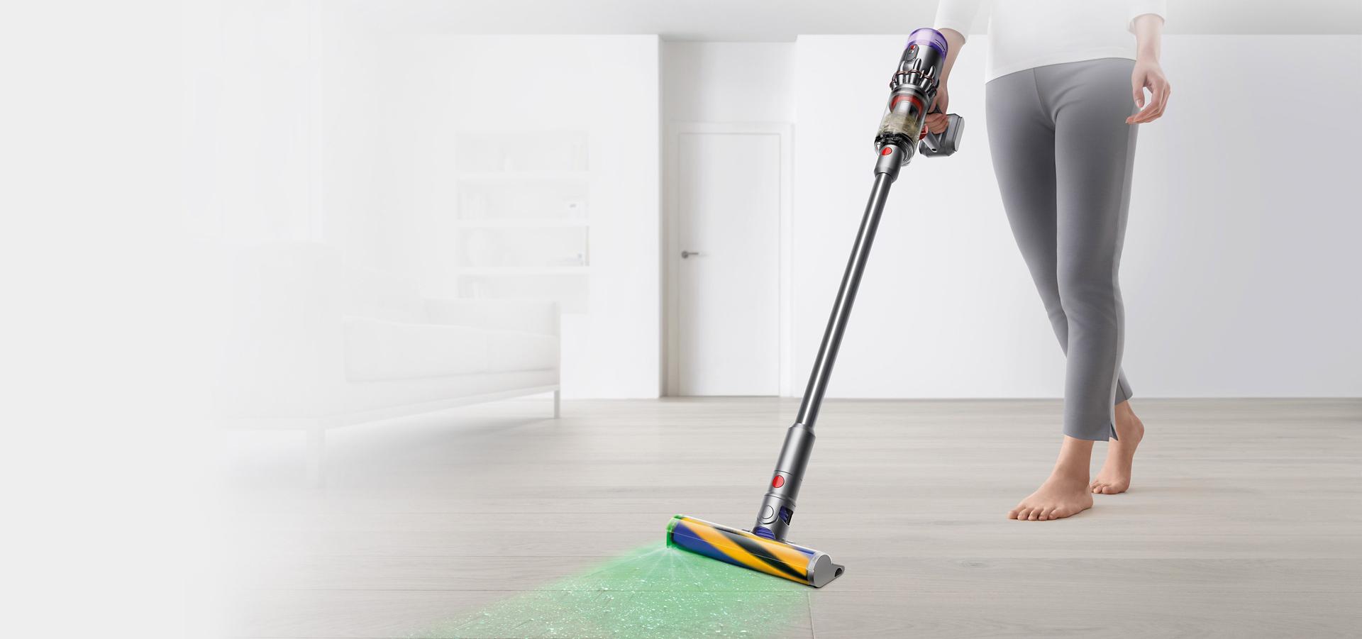 Dyson Micro illuminating and cleaning debris from a hard floor.