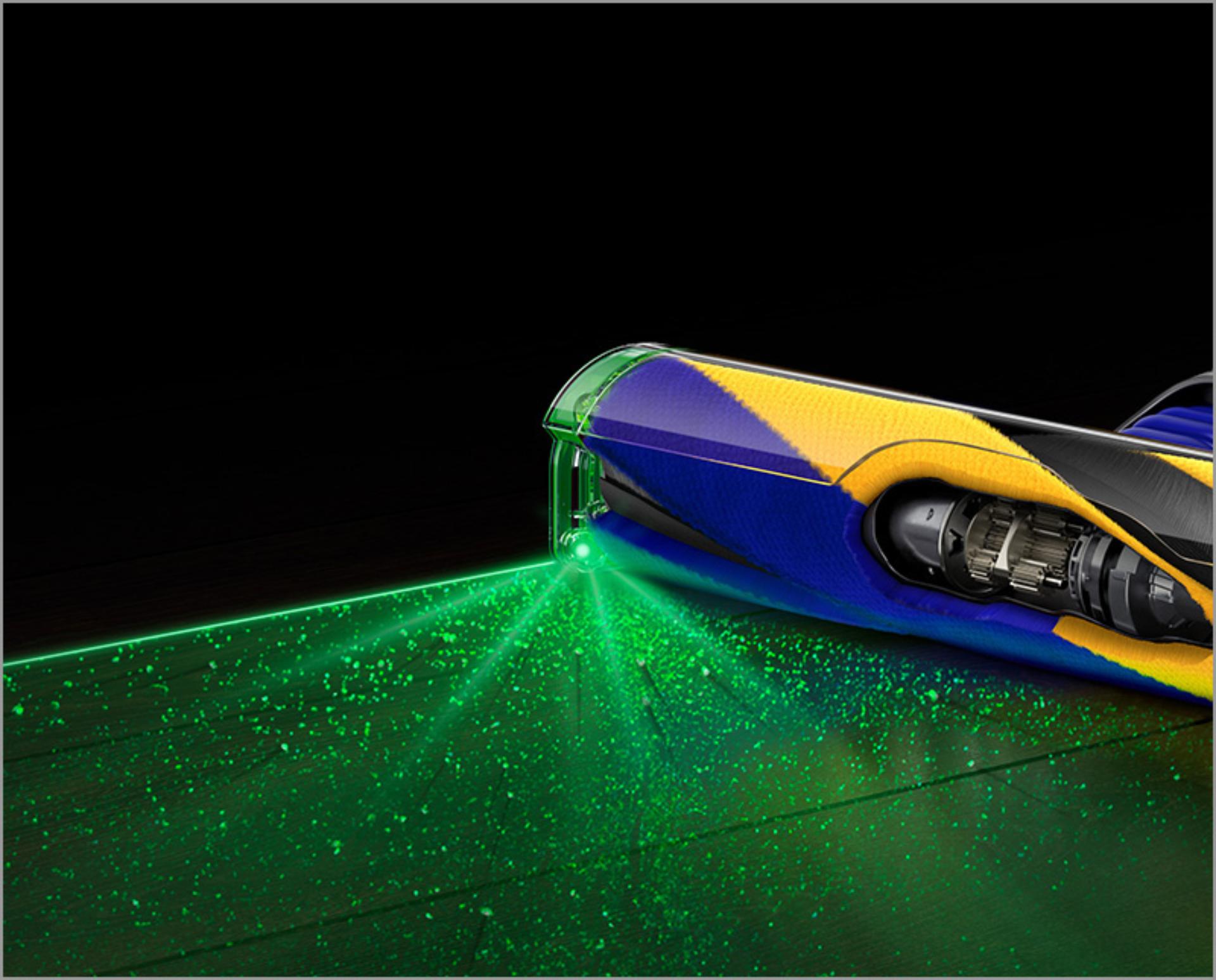 A cutaway of a Fluffy Optic cleaner head illuminating dust on a dark floor.
