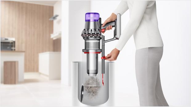 Woman emptying Dyson Outsize vacuum into bin