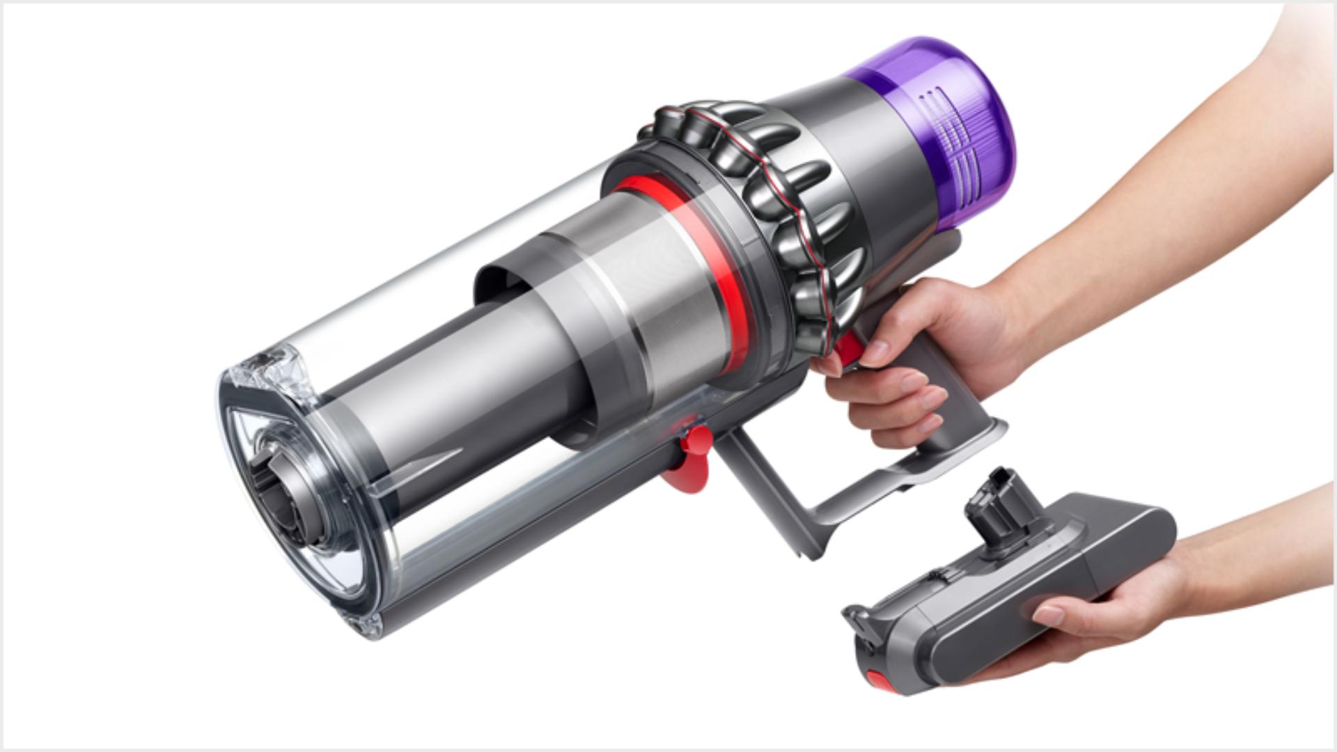 Hands attaching a Click-in battery to the Dyson Outsize vacuum
