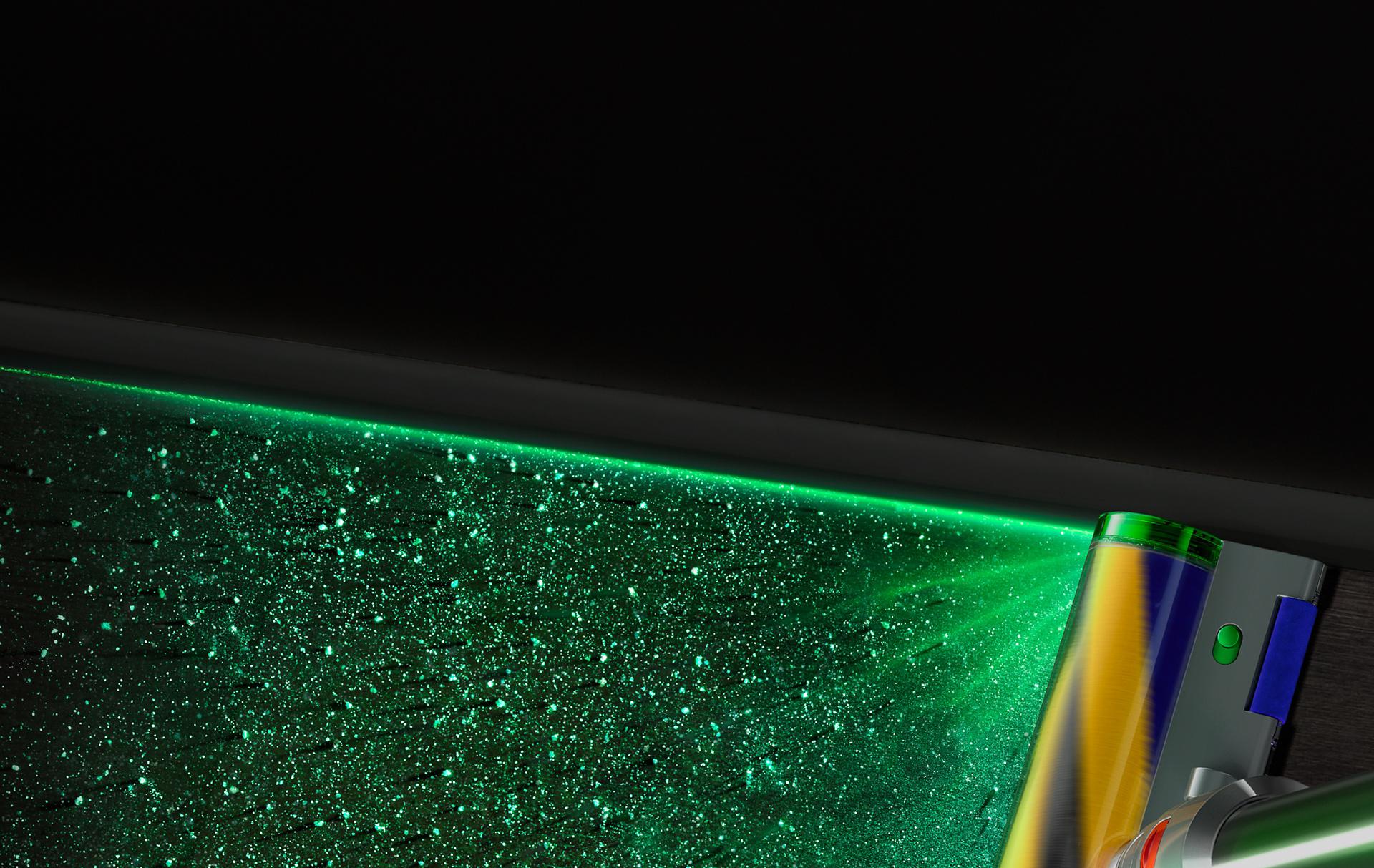 Close-up of green laser highlighting hidden dust