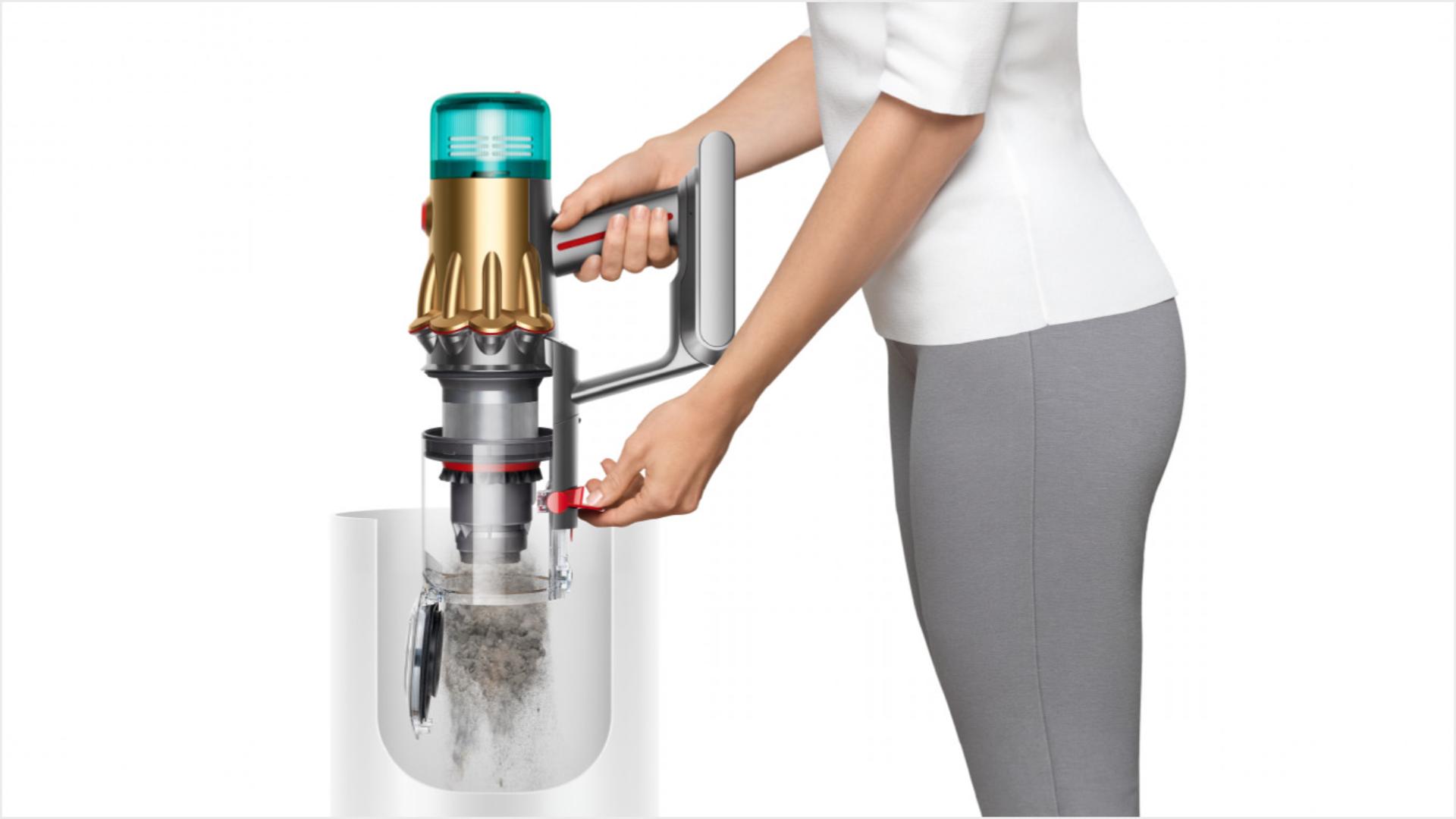 Woman emptying Dyson vacuum into the bin