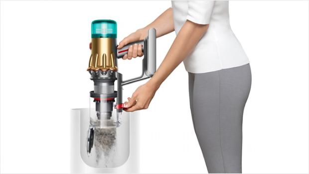 Woman emptying Dyson vacuum into the bin
