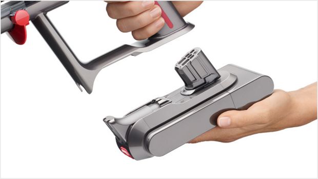 Person replacing the vacuum's Click-in battery