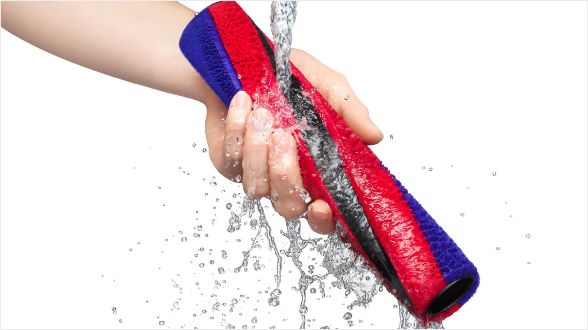 Person washing the Slim Fluffy brush bar under a tap