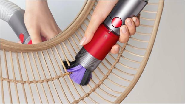 Scratch-free dusting brush cleaning a delicate mirror frame.