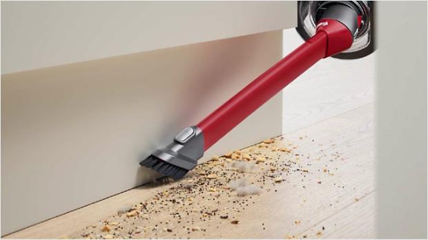 Awkward gap tool cleaning the space between a floor and a wall.