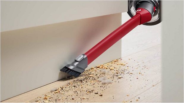 Awkward gap tool cleaning the space between a floor and a wall.