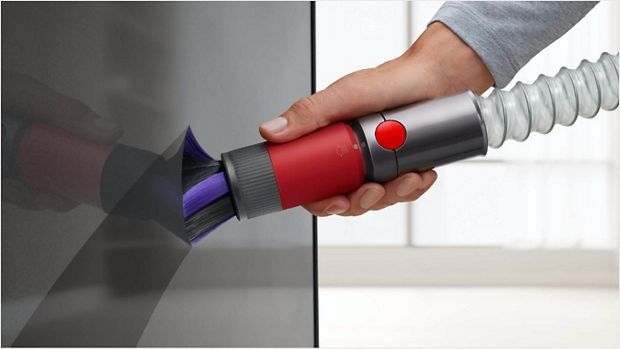 Extension hose being used to reach down low in a kitchen.