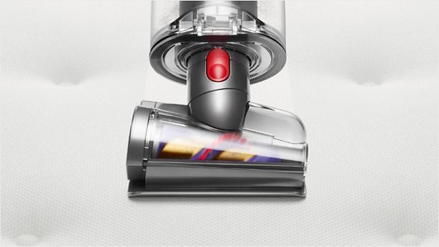 Hair screw tool cleaning a mattress.