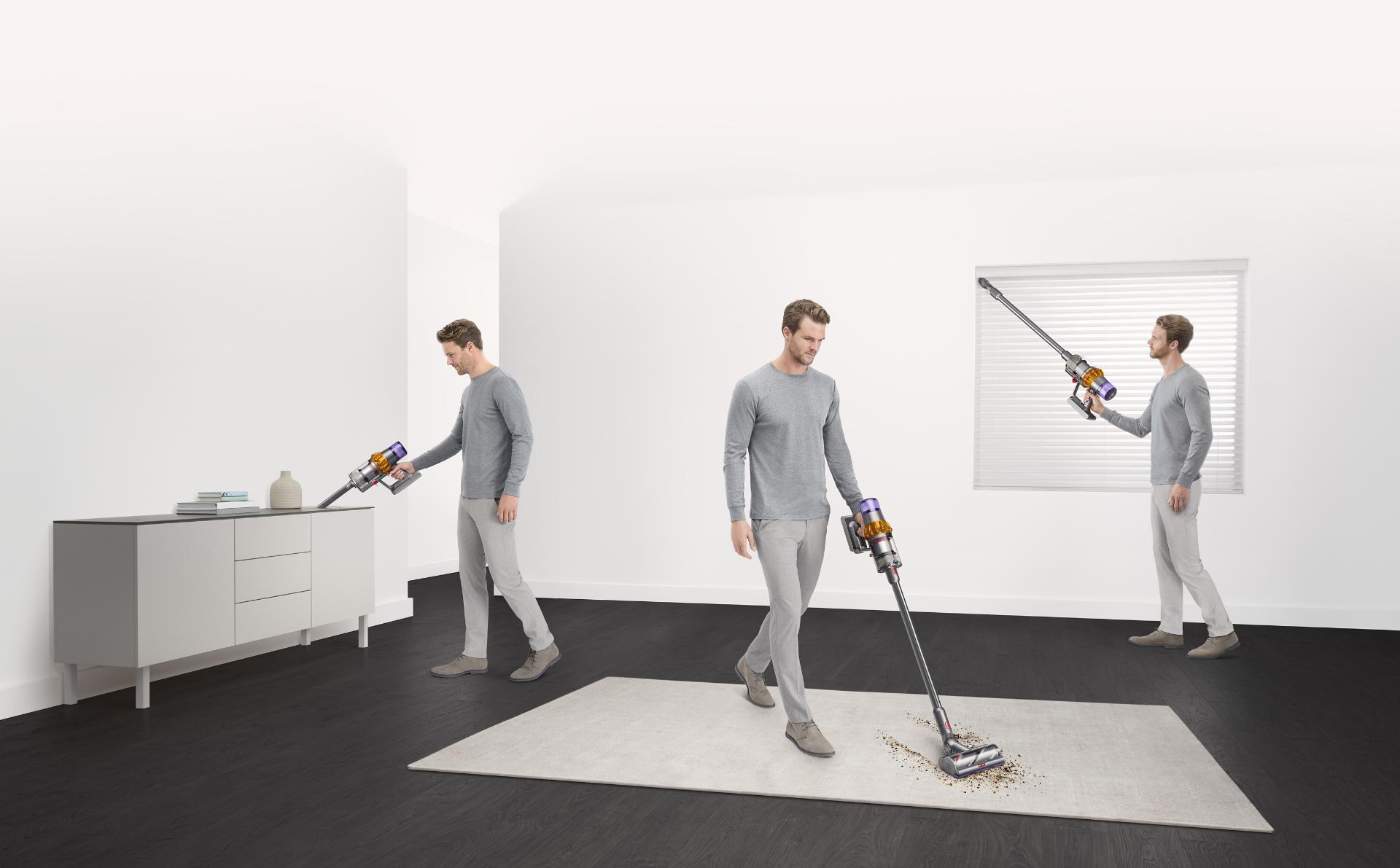 Woman pushing Dyson Outsize vacuum from hard floor to carpet