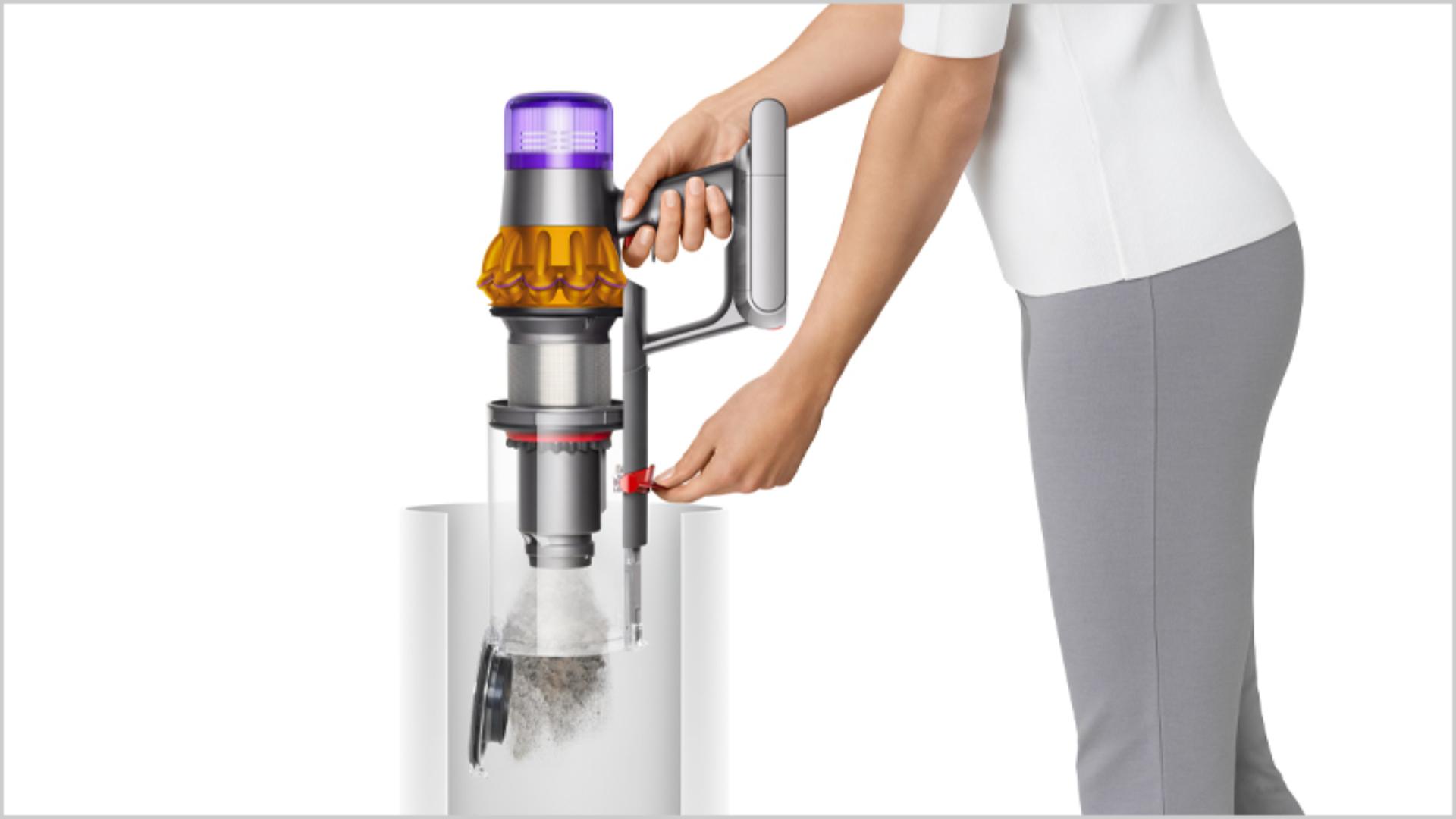 Woman emptying Dyson vacuum into the bin