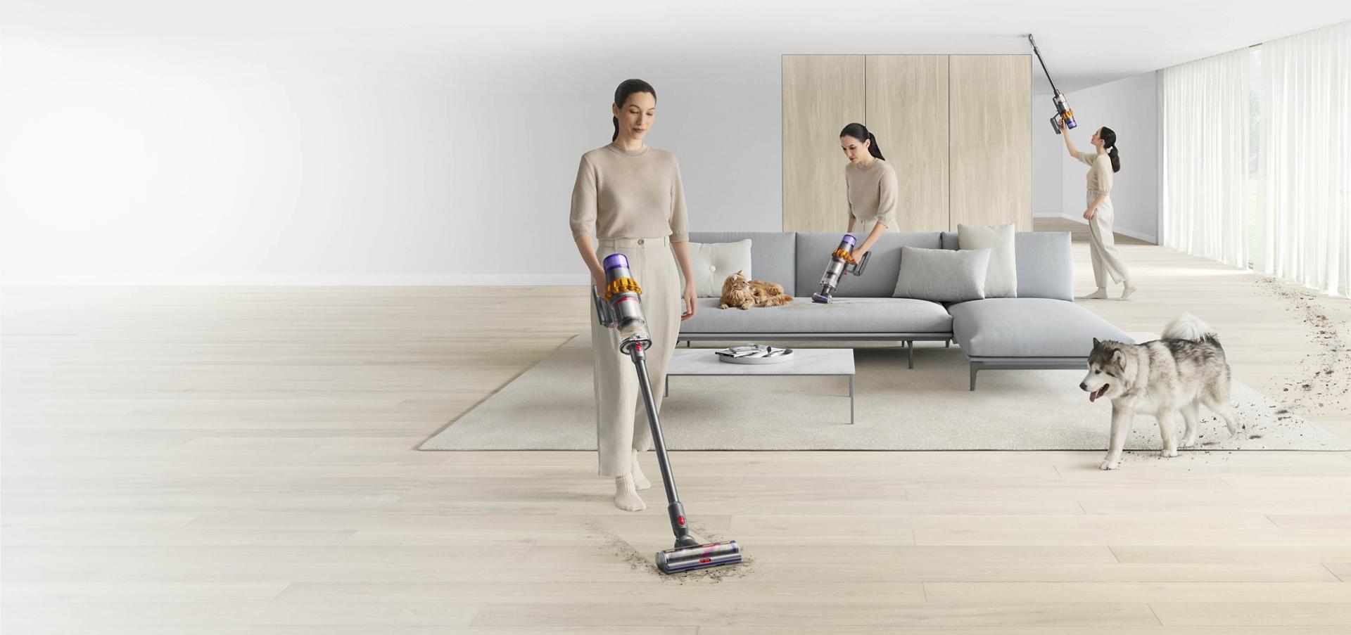 A woman vacuuming a large room using the Dyson V15 detect vacuum in cordless and handheld modes.