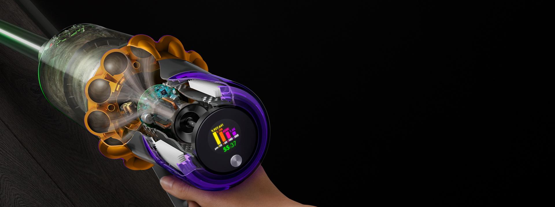 A cutaway of the side of a Dyson V15s showing debris being filtered with the LCD user screen displaying the run time and particle counts.