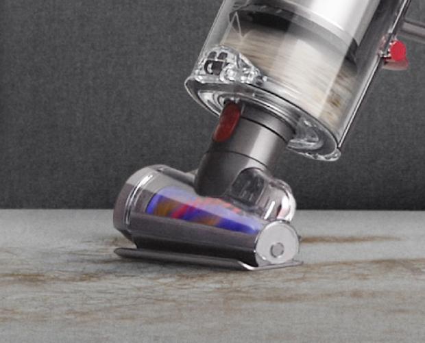 Hair screw tool picking up hair from sofa.