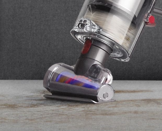 Hair screw tool picking up hair from sofa.