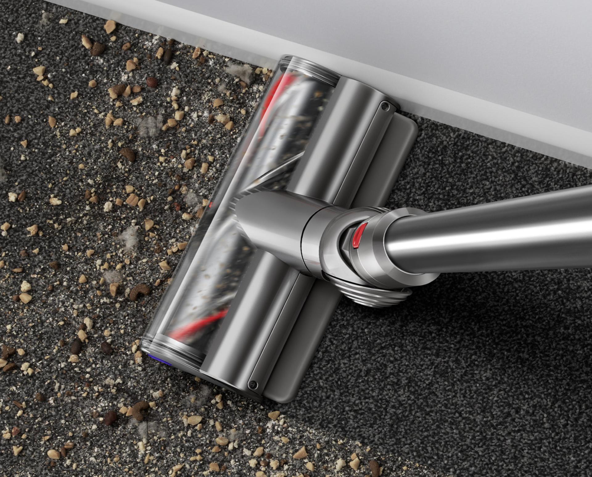 Digital Motorbar cleaner head picking up debris from floor.