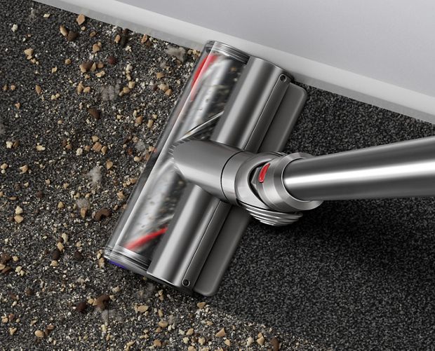 Digital Motorbar cleaner head picking up debris from floor.