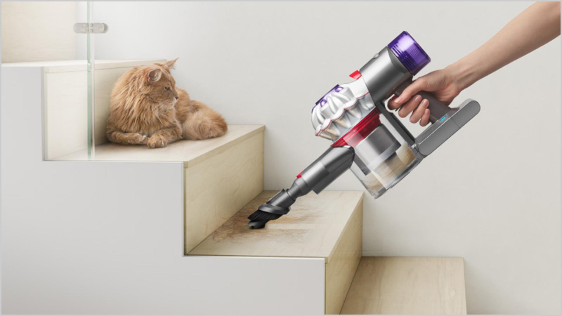 Dyson V7 Advanced with combination tool attached, being used on hard-floor stairs