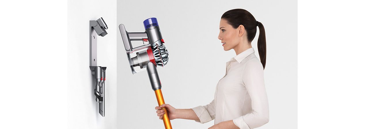 Woman storing Dyson V8 vacuum in Wall Dok