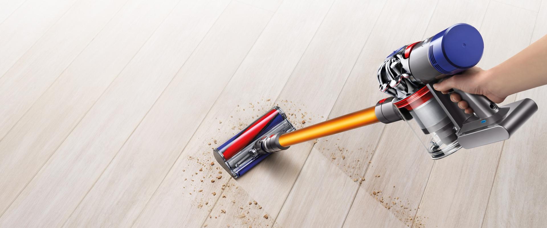 Dyson V8 vacuum cleaner picking up debris from carpet