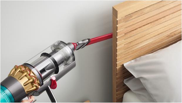 Awkward gap tool cleaning behind a bed frame