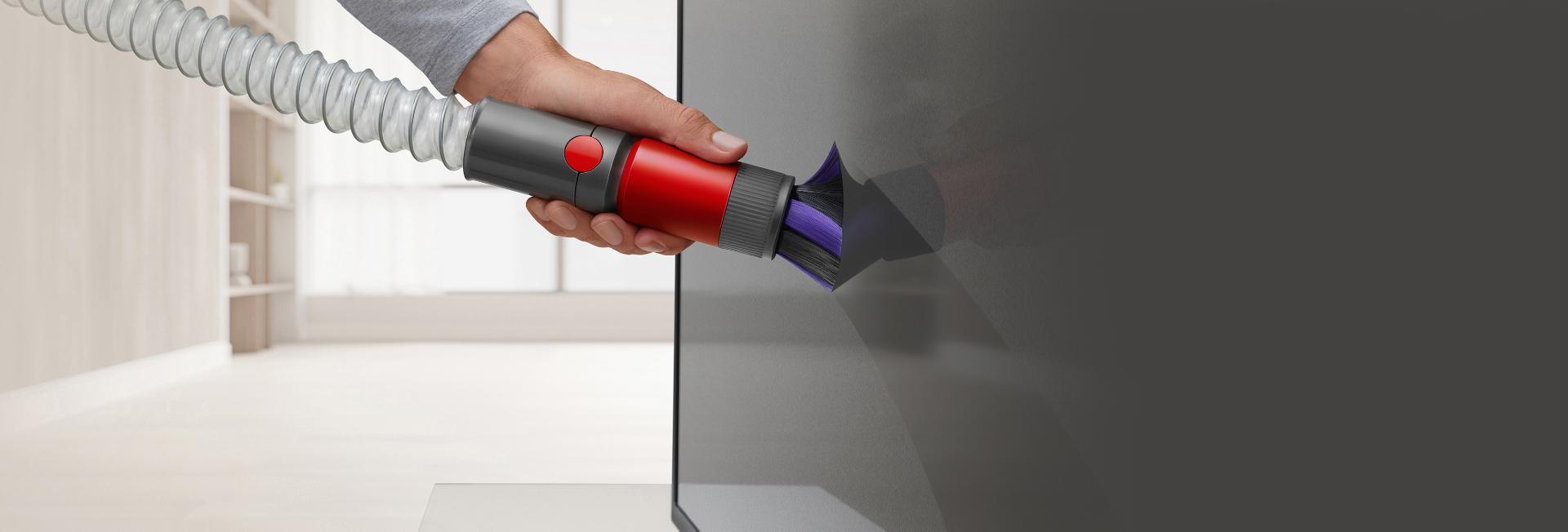 Scratch-free dusting brush cleaning a TV screen