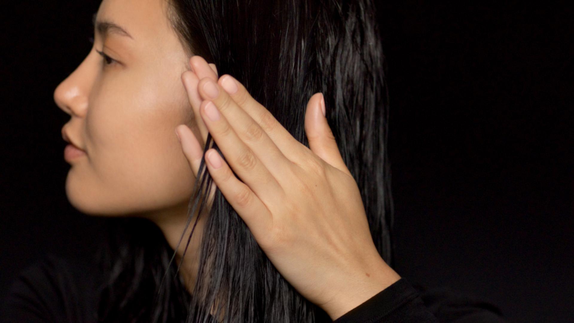 A model applying Pre-style cream before styling