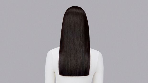 Naturally straight dark hair styled with Dyson Chitosan Pre-style cream and the Dyson Airstrait. Seen from behind.