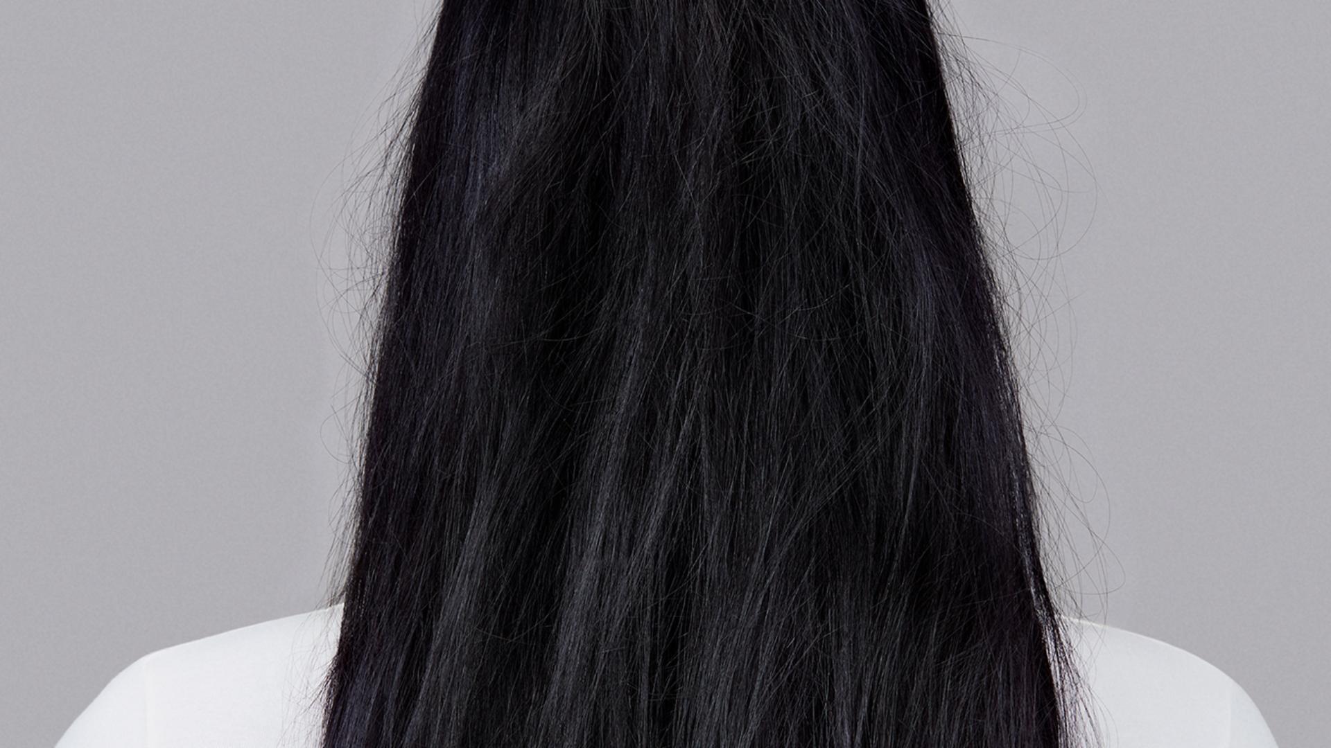 Model with long wavy brunette hair.