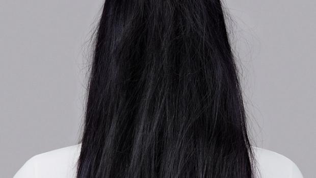 Model with long wavy brunette hair.